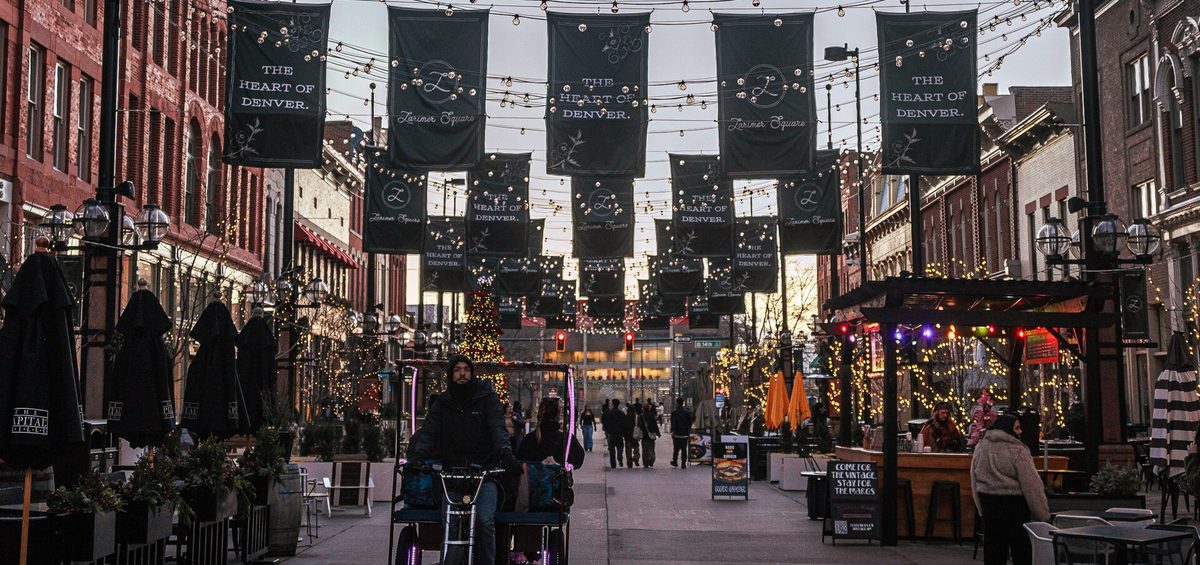 Larimer Square in downtown Denver at dusk, with string lights over the street